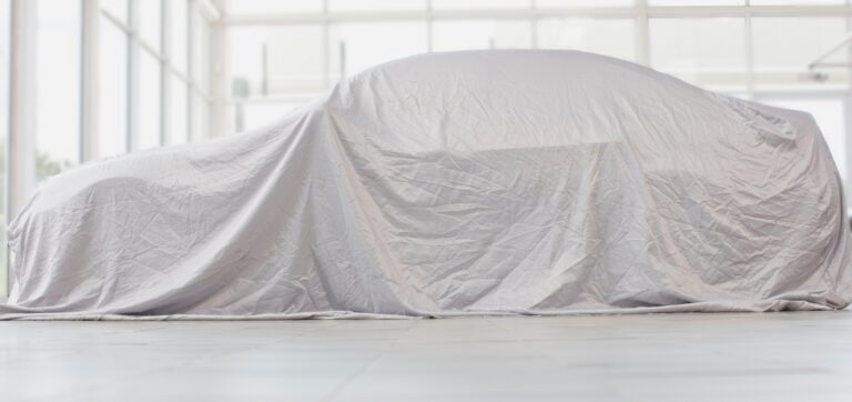 Car covered in cloth in garage