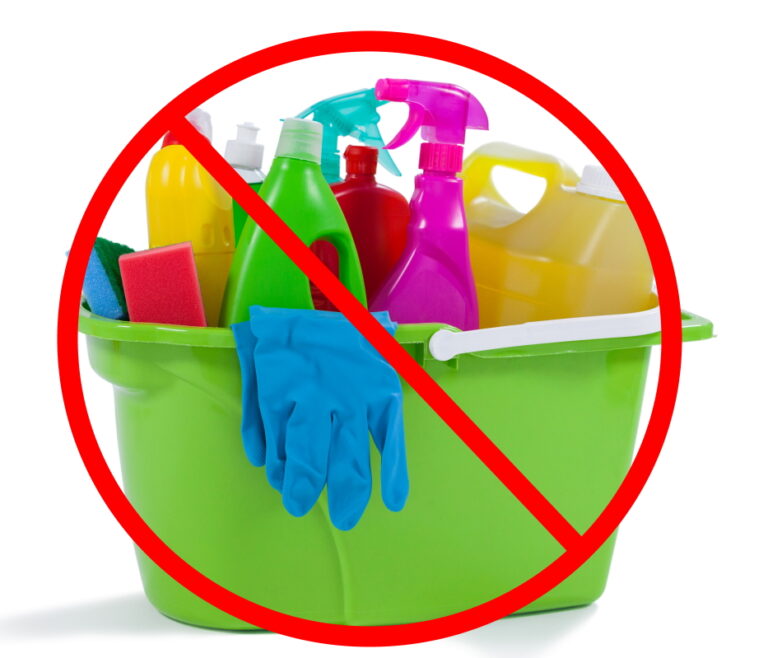 Various household cleaning supplies in a bucket on white background